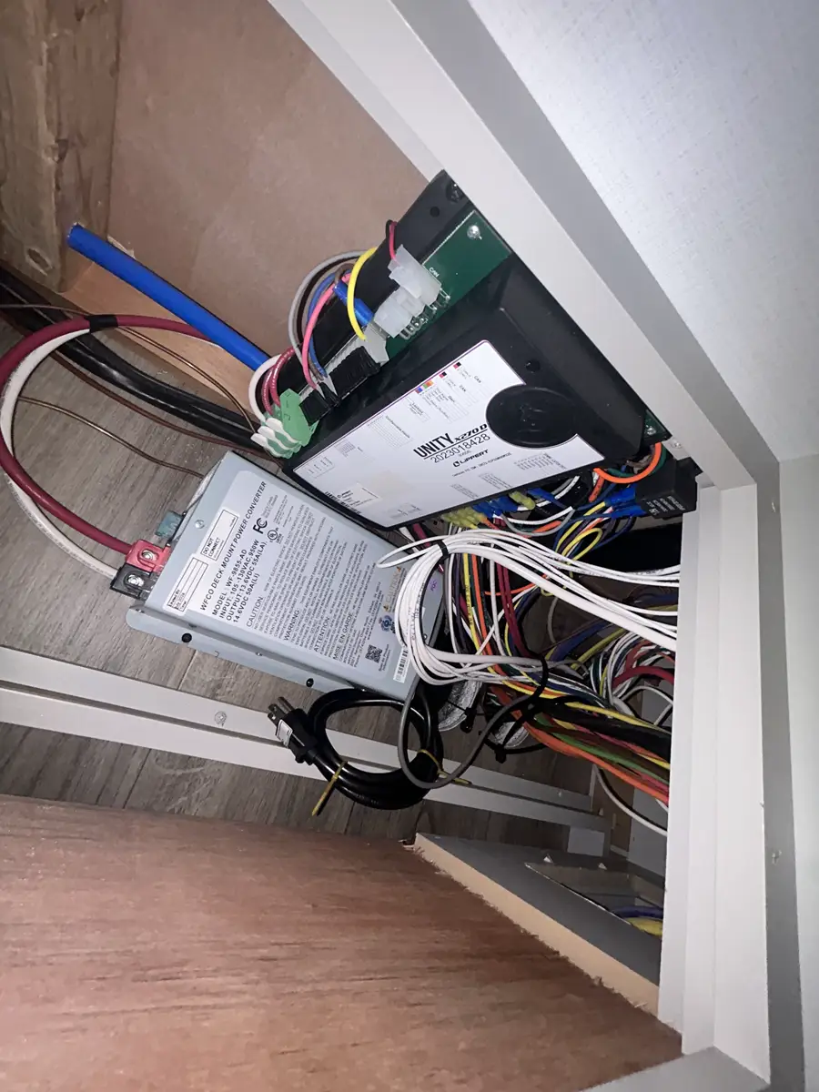 Trailer systems and hitch-area work during a mobile RV service call.