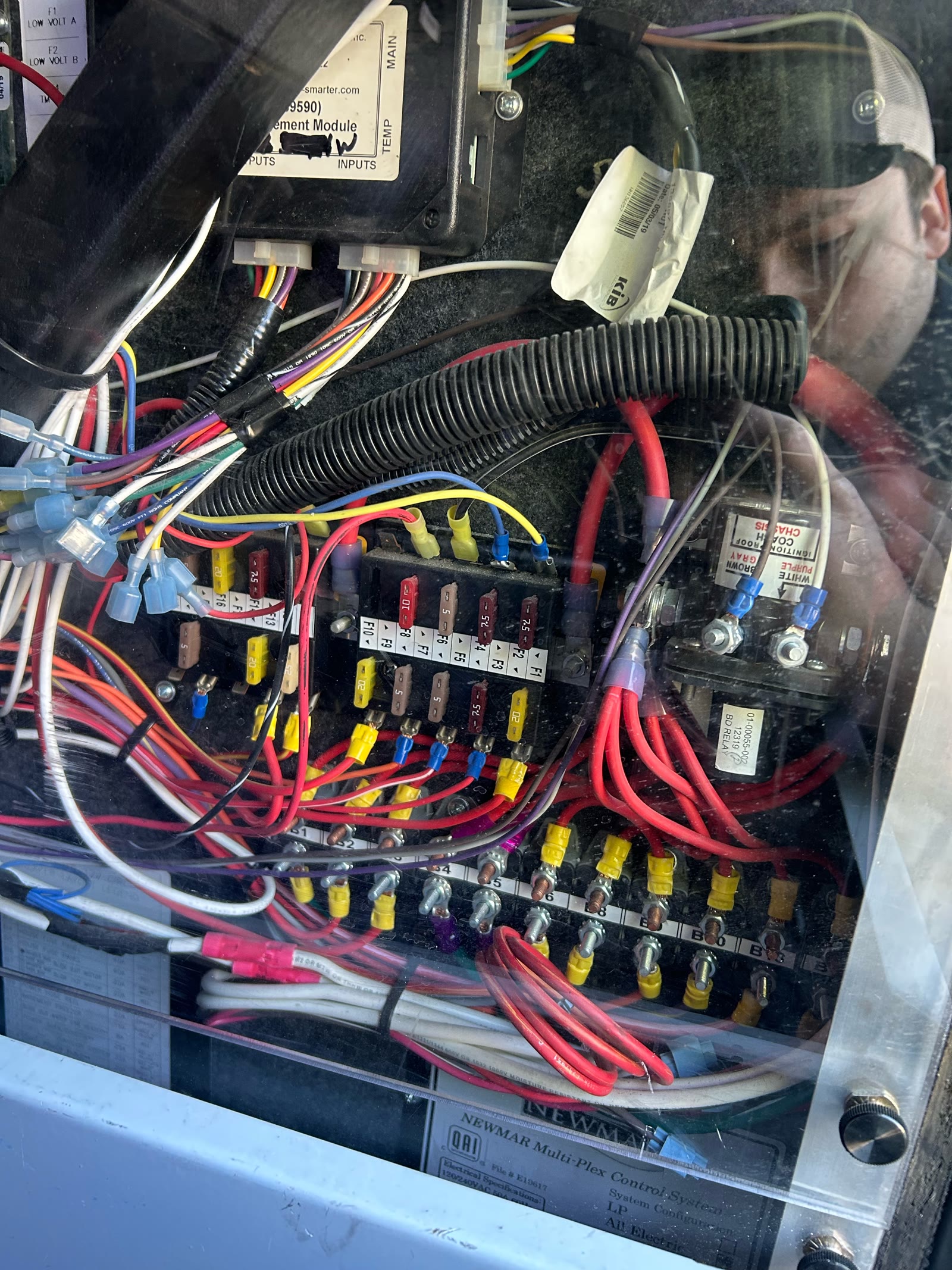 Advanced RV electronics and systems bay during mobile troubleshooting.